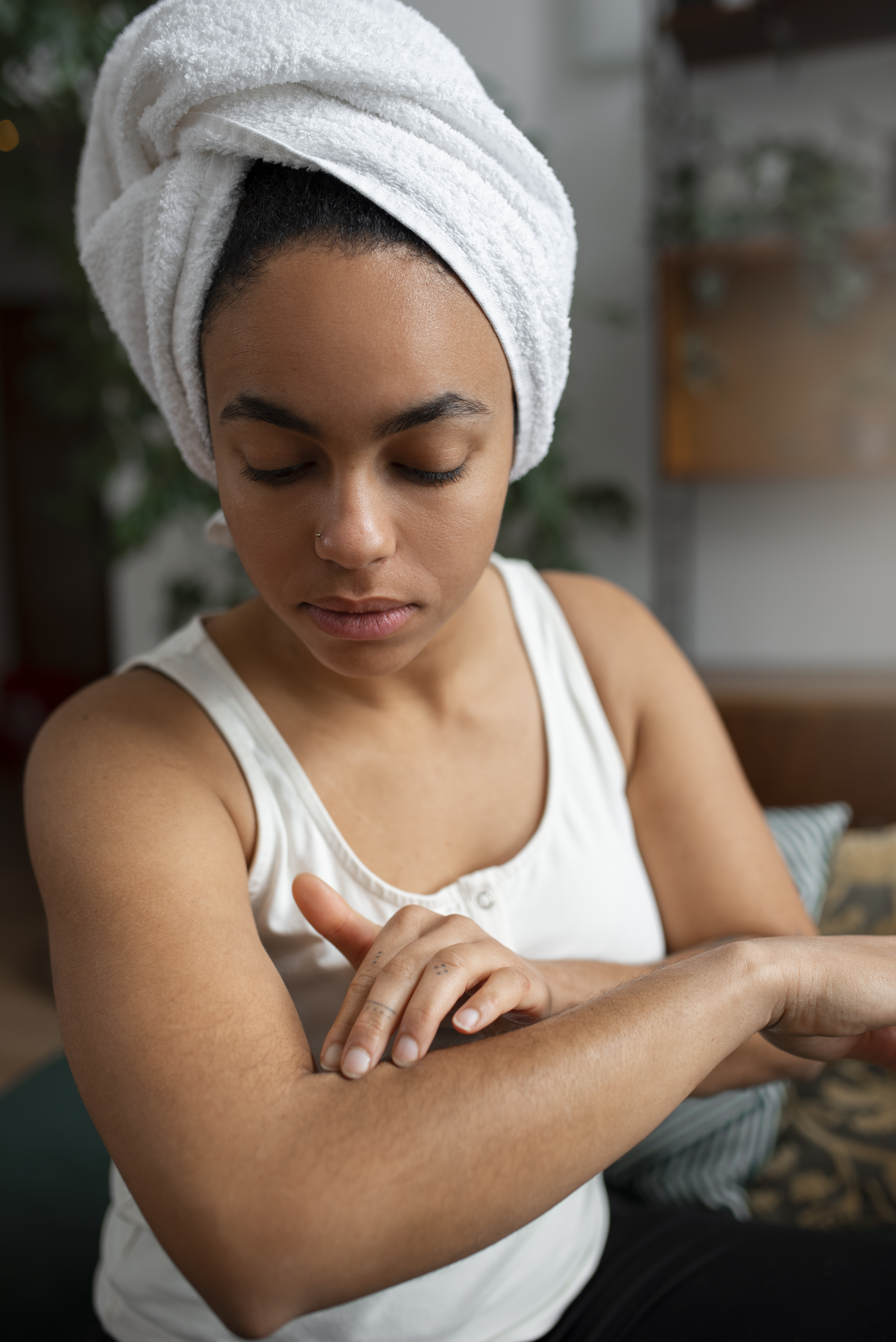 A picture showing a woman applying coconut oil to a scar on her forearm.