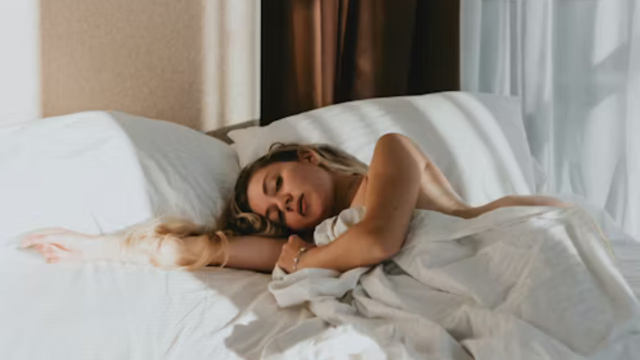 A picture showing a woman sleeping on a bed
