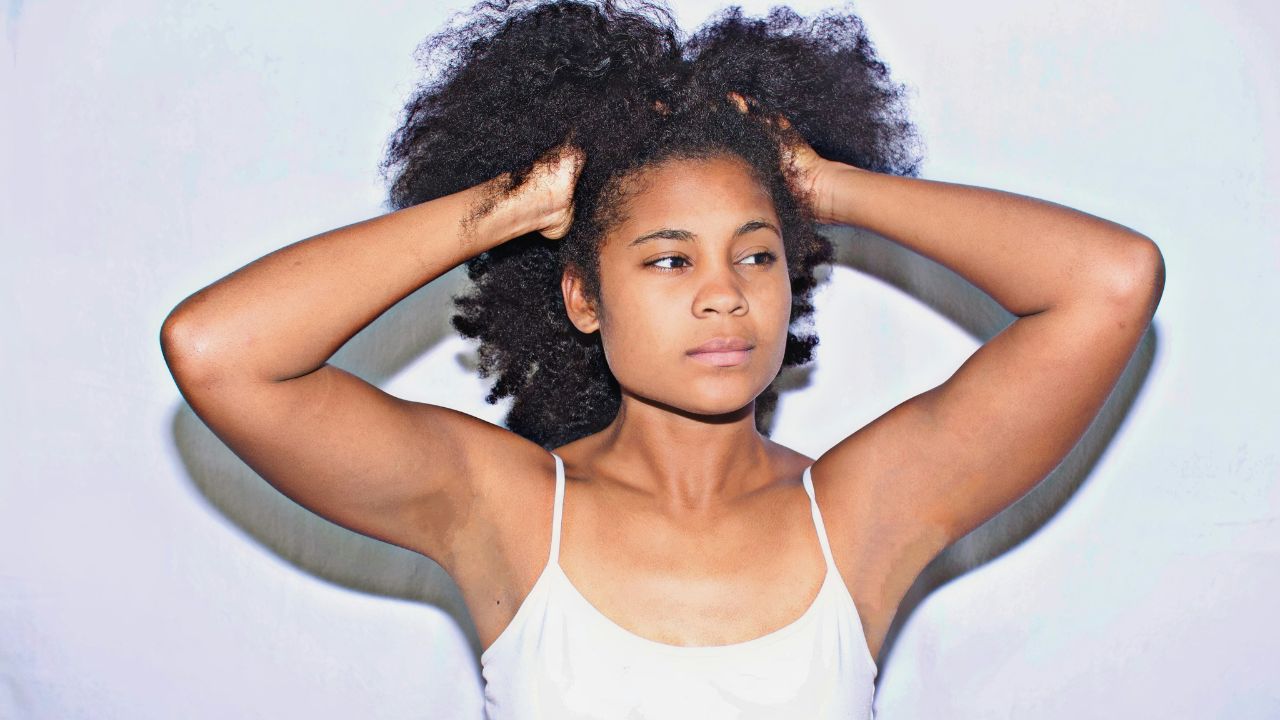 A picture showing a woman with healthy hair, glowing skin, and strong nails