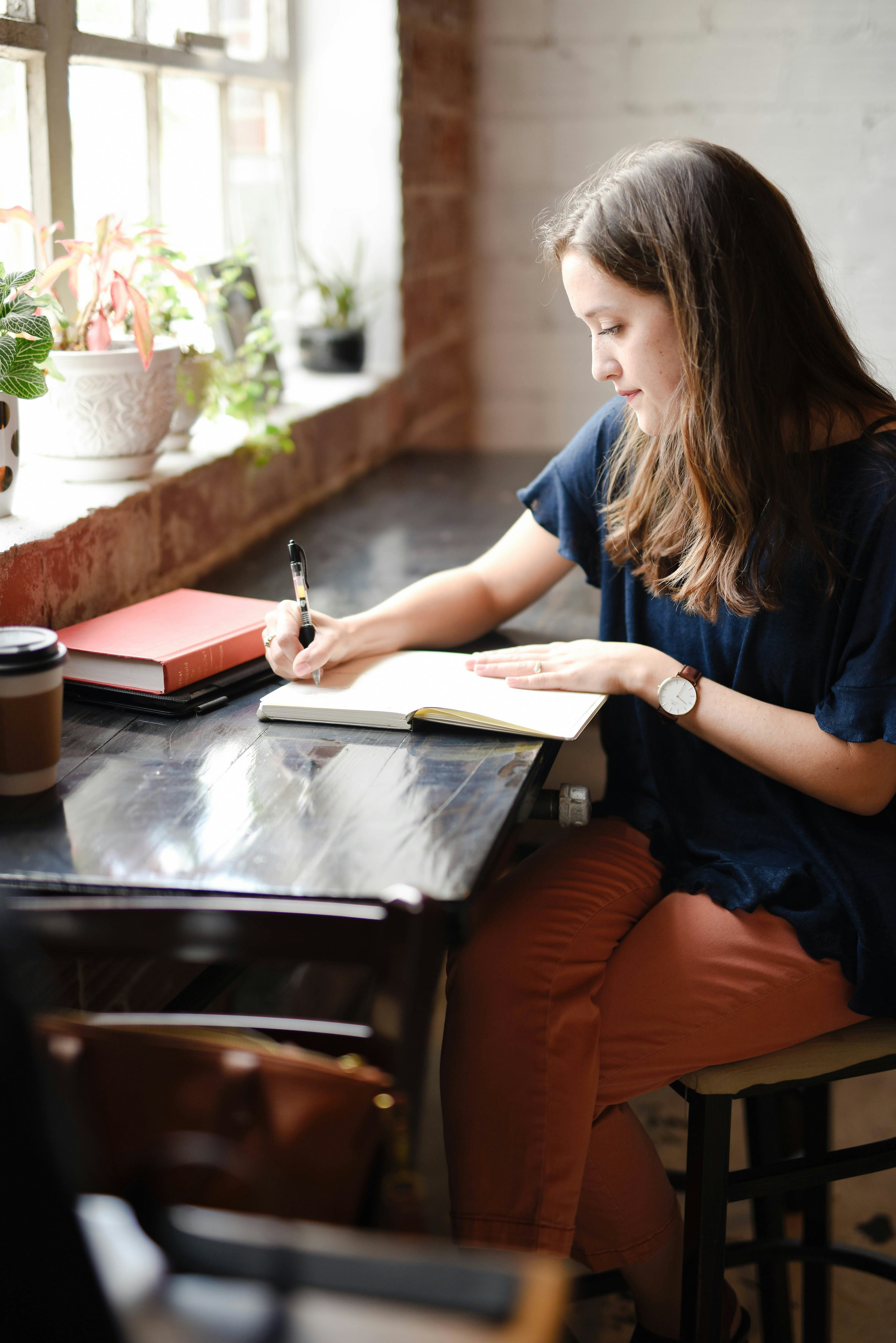 A picture showing a woman journaling.
