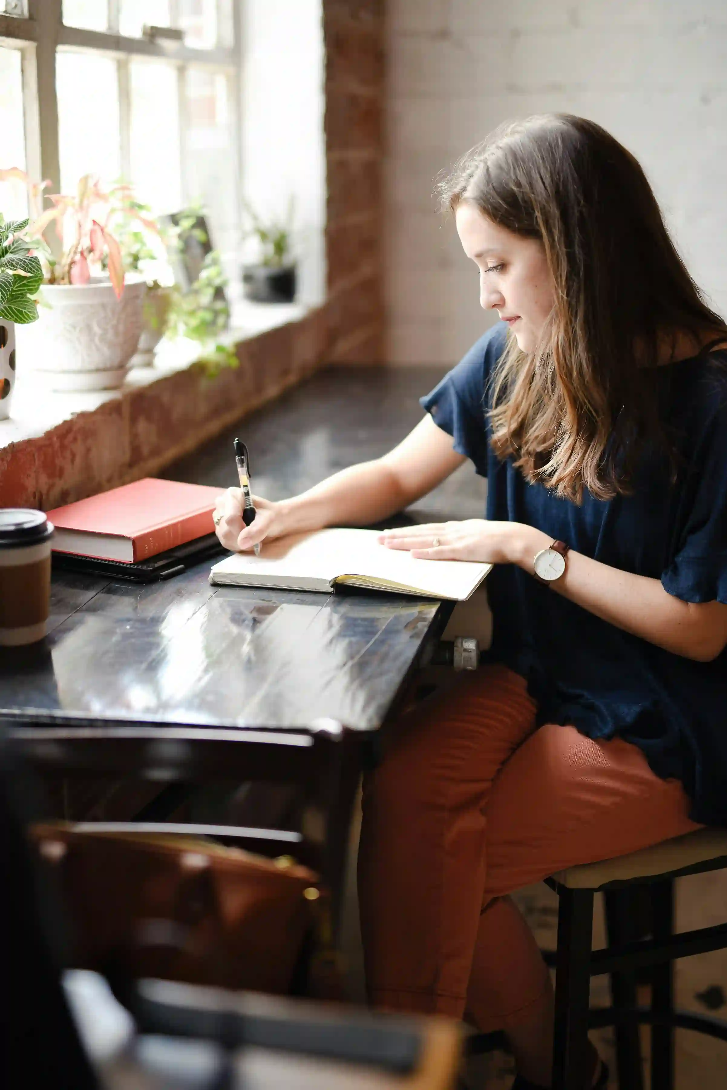 A picture showing a woman journaling.