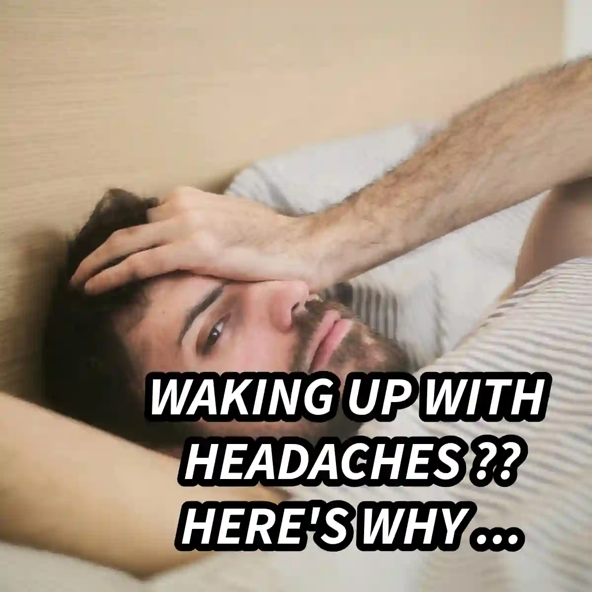 Man waking up holding his head in pain, experiencing a morning headache