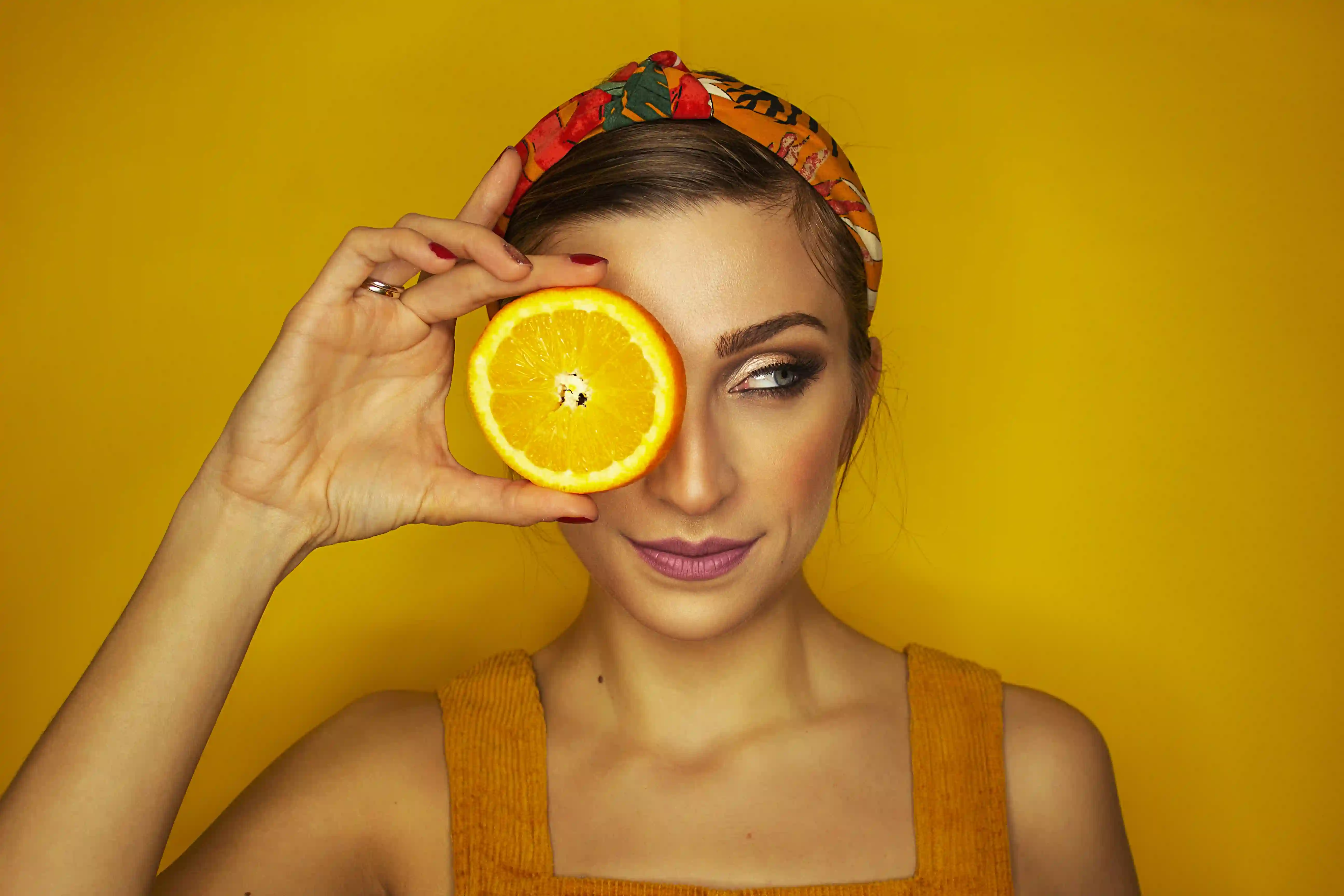 A picture showing a woman with an orange.